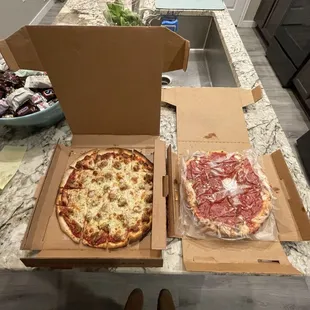 two pizzas in boxes