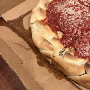 Grease soaked box leaking on a wood countertop