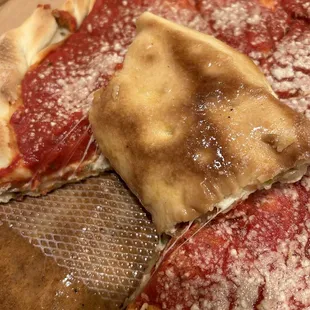 Close up of a grease soaked box and the underside of a grease soaked crust