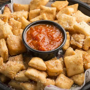 a plate of cheese crackers with a dipping sauce