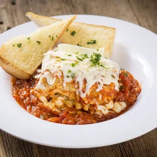 a plate of lasagna with bread
