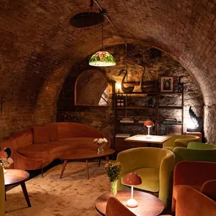 a living room with a brick wall