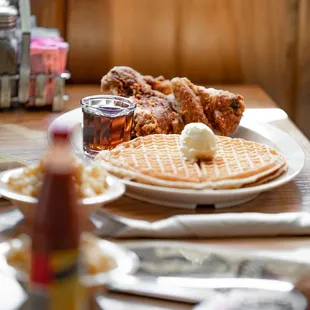 a plate of fried chicken and waffles on a