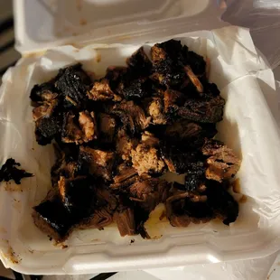 a styrofoam container filled with meat