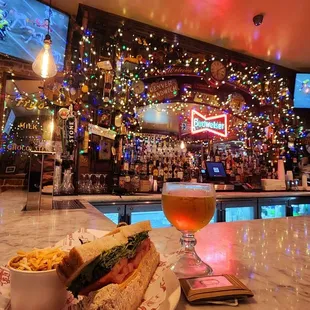 a glass of beer and a sandwich