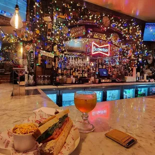a glass of beer and a sandwich