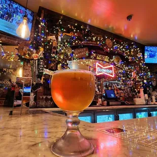a glass of beer on the bar