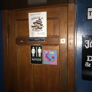 a wooden door with stickers on it