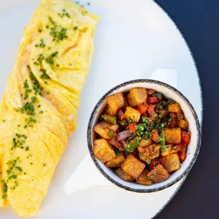 an omelet and a bowl of vegetables