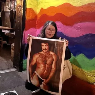 a woman holding a picture of a man