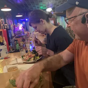 Buddies Tom and Andrea enjoying Sally's specials at the bar.