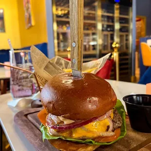 a cheeseburger on a cutting board