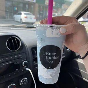 a hand holding a cup of bubble tea