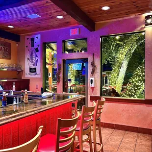 a bar with red stools