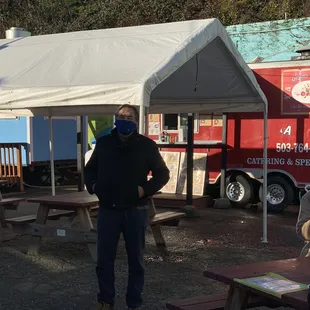 a man standing in front of a food truck