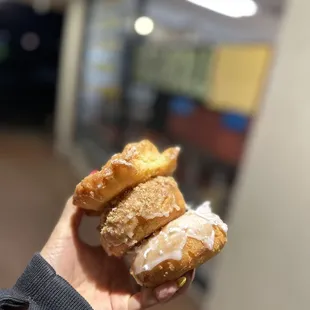 a person holding a donut in their hand