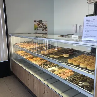 a display case with a variety of donuts