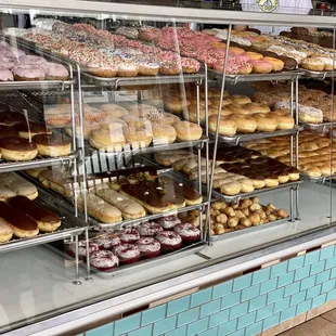 a variety of doughnuts in a display case