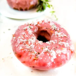 a pink donut with sprinkles on top