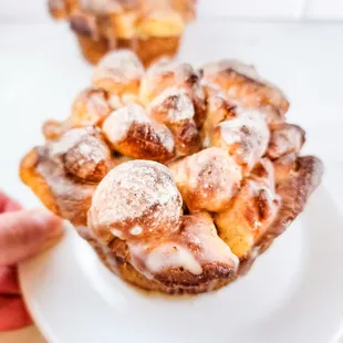 a person holding a plate of doughnuts