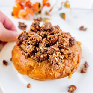 a hand reaching for a donut