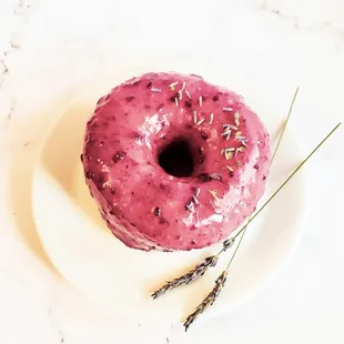 a pink donut with lavender sprinkles