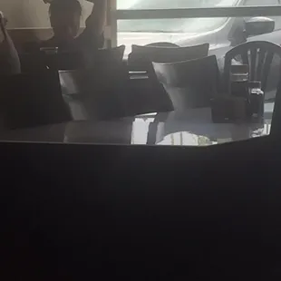 Girl possibly manager just sitting there playing on phone.