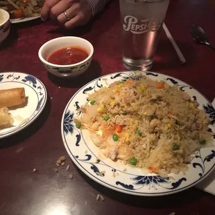 Chicken fry rice with vegetables and spring rolls