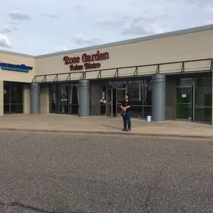a woman standing in front of the store