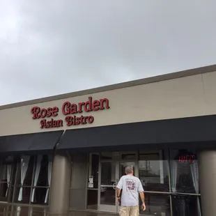 a man walking in front of the building