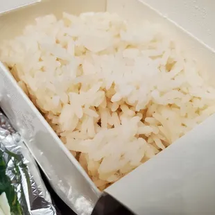 Takeout rice, likely included with most entrees