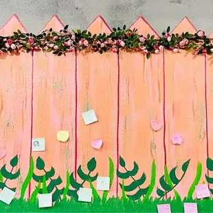 a pink fence decorated with flowers