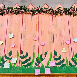 a pink fence with flowers