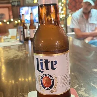 a bottle of lite beer on a coaster