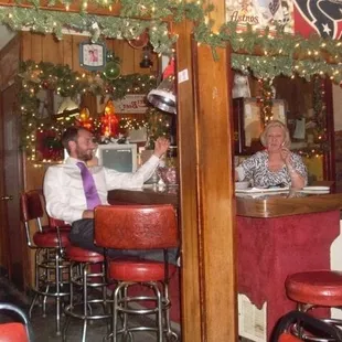 a man and a woman sitting at a bar