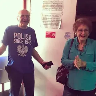 a man and a woman standing in front of a door