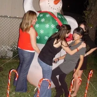 a group of people standing around a snowman