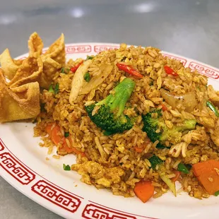 a plate of fried rice and vegetables