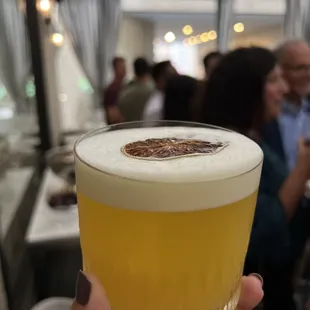 a person holding a glass of beer