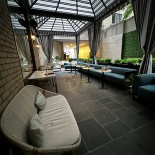 a patio with a couch and chairs