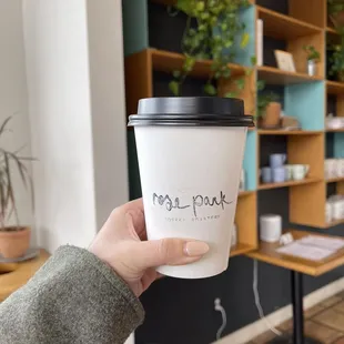 a hand holding a cup of coffee