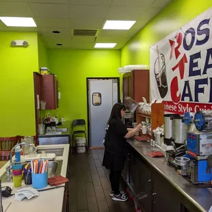 a woman preparing a cup of coffee