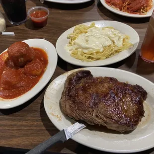 Ribeye dinner with fettuccine, raviolis, and meatball.