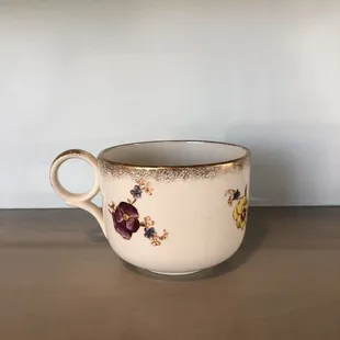 a coffee cup with a rosebud design