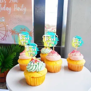 three cupcakes on a cake stand