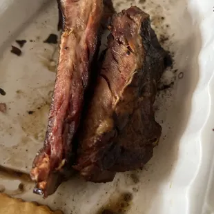 a plate of ribs and french fries