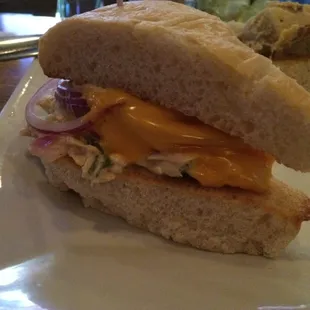 Half of a tuna melt on focaccia bread.