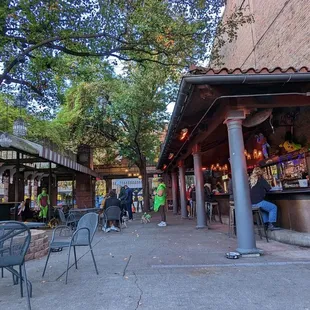 a cafe with tables and chairs on the sidewalk