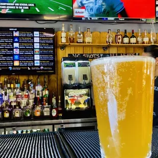 a glass of beer on a bar