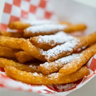 a basket of churrons with powdered sugar on top